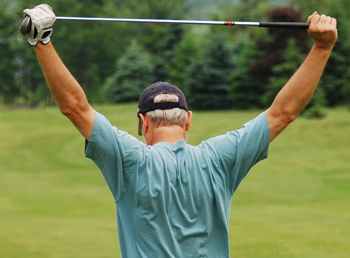 Back view of golfer stretching arms Back view of golfer stretching arms